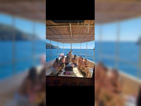 A lively group enjoys their time aboard a boat, surrounded by stunning ocean views — perfect for celebrations and memorable outings on the water.