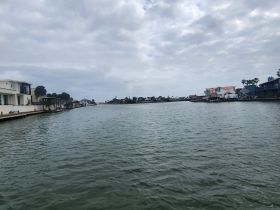 A view of a waterway lined with houses, but the image lacks clarity and detail.
