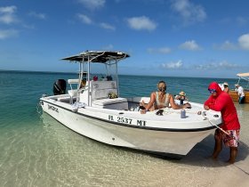 A lively group enjoys a day at the beach aboard a boat, showcasing the perfect blend of sun, fun, and water activities.