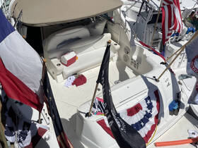 An interior view of a boat showcasing comfortable seating and a helm area, perfect for relaxing and navigating on the water.
