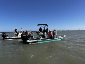A group of people enjoy a day on the water aboard their boats, showcasing the camaraderie and excitement of boating adventures.