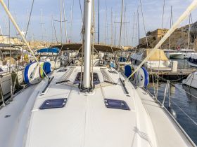 A detailed view of a yacht docked in a marina, showcasing its sleek design and surrounding boats — perfect for exploring coastal destinations.