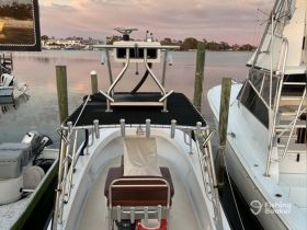 A detailed view of the helm area inside a boat, showcasing the console and seating, perfect for fishing or leisure outings.