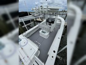 An interior view of a well-equipped boat helm showcasing the console and seating area, perfect for navigating the waters with comfort and style.