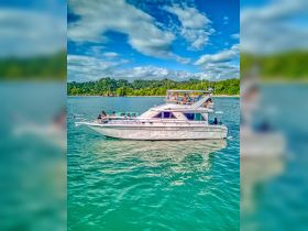 A lively group enjoys a day on the water aboard a spacious yacht, surrounded by stunning scenery — perfect for celebrations and adventures.