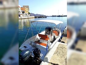 A sleek speedboat docked at a serene harbor, showcasing its modern design and fishing gear, perfect for a day on the water.