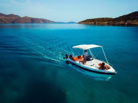 A scenic view of a boat cruising through crystal-clear waters, showcasing the beauty of the landscape and the joy of boating adventures.
