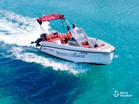 A sleek speedboat named 'Mirabello Boats' glides through crystal-clear waters, perfect for rental and fishing trips in beautiful coastal settings.