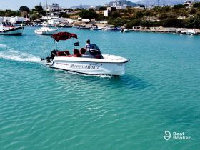A sleek speedboat navigates through turquoise waters, showcasing the perfect rental option for boating and fishing trips in the beautiful coastal area.