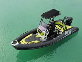 A sleek speedboat navigates through clear turquoise waters, showcasing its modern design and inviting atmosphere for thrilling water adventures.