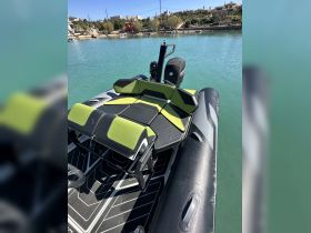 Interior view of a stylish boat seating area, showcasing comfortable green and black cushions, perfect for relaxing on the water.