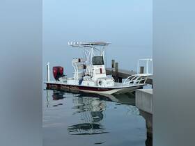 A sleek speedboat named 'Shallow Stalker' docked peacefully at the pier, reflecting beautifully in the calm waters — perfect for fishing or leisure outings.