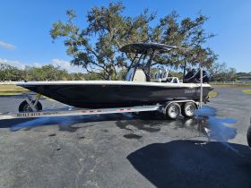 A sleek Shearwater boat displayed on its trailer, showcasing its design and features against a clear blue sky.