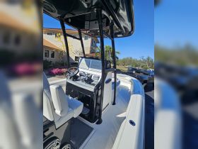 A detailed view of the helm and seating area inside a modern boat, showcasing the sleek design and advanced Garmin navigation system.