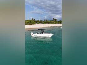 A sleek speedboat anchored in crystal-clear waters, surrounded by a picturesque beach and lush greenery — perfect for a day of relaxation on the water.