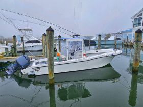 A fishing boat docked at the marina, showcasing its sleek design and readiness for the next adventure on the water.