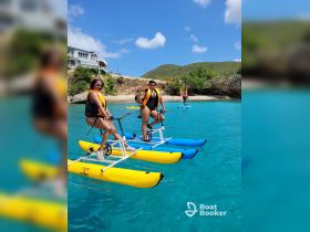 Two friends enjoy paddleboarding in crystal-clear waters, showcasing a fun fitness activity perfect for group adventures in a tropical paradise.