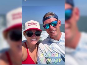 A cheerful couple enjoys a sunny day on the water, capturing the essence of a fun boating adventure together.