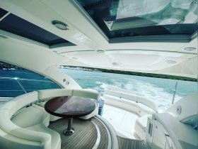 The elegant interior of a yacht showcases a stylish seating area and helm, perfect for relaxing while cruising on the water.