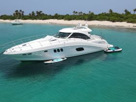 A stunning yacht named 'Lady Penny' anchored in crystal-clear waters, showcasing the perfect setting for luxurious boating adventures.