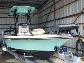 A detailed view of the interior of a sleek boat, showcasing the helm and seating area, perfect for fishing or leisure outings.