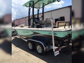 A sleek Bluewave boat displayed on a trailer, showcasing its stylish design and features, perfect for fishing or leisure outings.