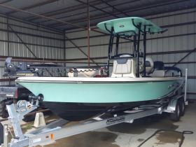 A sleek fishing boat showcased in a storage facility, highlighting its design and features, perfect for anglers looking for their next adventure on the water.