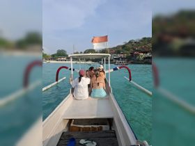 A group of friends enjoys a scenic boat ride, soaking in the sun and beautiful turquoise waters — perfect for a day of adventure and relaxation.