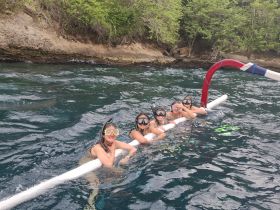 A group of friends enjoys snorkeling in clear waters, showcasing the fun and adventure of underwater exploration.