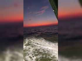 A stunning sunset over the ocean, capturing the serene beauty of twilight on the water — perfect for evening cruises and scenic views.