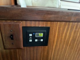 Close-up of a control panel inside a boat, showcasing the temperature setting and features — essential for onboard comfort and convenience.