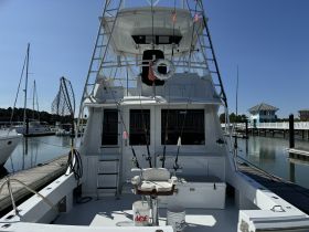 Interior view of a fishing boat showcasing the helm and fishing gear, perfect for anglers looking to enjoy a day on the water.