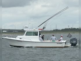 A group enjoys a fishing trip aboard a Steiger Craft boat, showcasing camaraderie and the thrill of on-water activities.