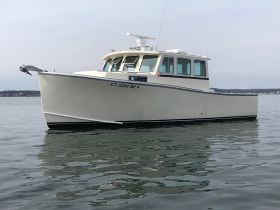A striking view of a well-crafted boat gliding through calm waters, showcasing its elegant design and structure.
