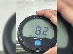 A close-up of a speedometer displaying a maximum speed of 82, showcasing essential boating equipment for tracking performance on the water.