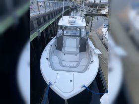 A clean and spacious interior view of a boat's helm and seating area, showcasing modern design and comfort for a great day on the water.