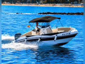 A speedboat glides through the sparkling blue waters, showcasing an exhilarating day on the water, perfect for adventure seekers.