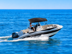A speedboat glides through crystal-clear waters, showcasing an exhilarating day on the water — perfect for adventure seekers and boating enthusiasts.