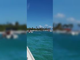 A vibrant scene of multiple boats navigating through clear turquoise waters, showcasing a lively coastal atmosphere perfect for boating adventures.