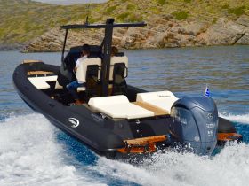 A sleek speedboat navigates through clear waters, showcasing an exciting day on the water with passengers enjoying the ride.