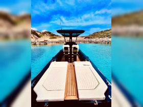 A stylish interior view of a boat featuring comfortable seating and a well-designed helm, perfect for enjoying a day on the water.