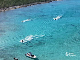 Thrilling jet ski action on crystal-clear turquoise waters, showcasing the excitement of water sports in a stunning tropical setting.