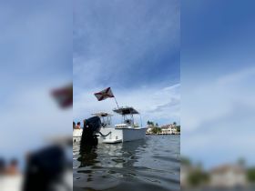 A sleek speedboat with a Florida flag is anchored, showcasing a beautiful waterfront view — perfect for exploring the scenic waterways.