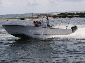 A lively group enjoys a thrilling ride on a speedboat, showcasing the excitement of fishing adventures on the water.