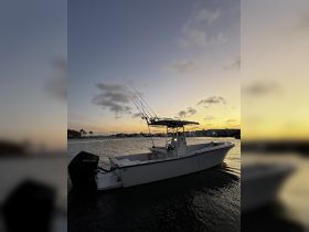 A sleek speedboat is anchored at sunset, showcasing its fishing gear and tranquil waters — perfect for evening fishing trips or leisurely cruises.