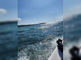 A beautiful view of sparkling ocean waters under a clear blue sky, capturing the essence of a perfect day on the water.
