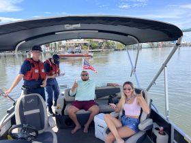 A lively group enjoys their time aboard a boat, showcasing a fun and relaxed atmosphere on the water.