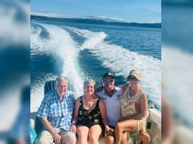 A cheerful group enjoys a boat ride, capturing the essence of fun and togetherness on the water — perfect for family outings or friends' adventures.