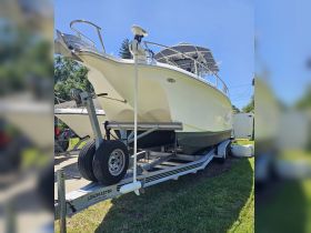 A clear view of a boat on its trailer, showcasing its sleek design and features, perfect for fishing or leisure outings.
