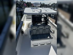 A well-equipped boat interior featuring comfortable seating and a modern helm, perfect for a day out on the water.